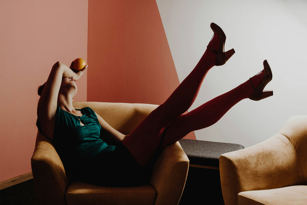 Woman sitting in a chair with her legs in the air