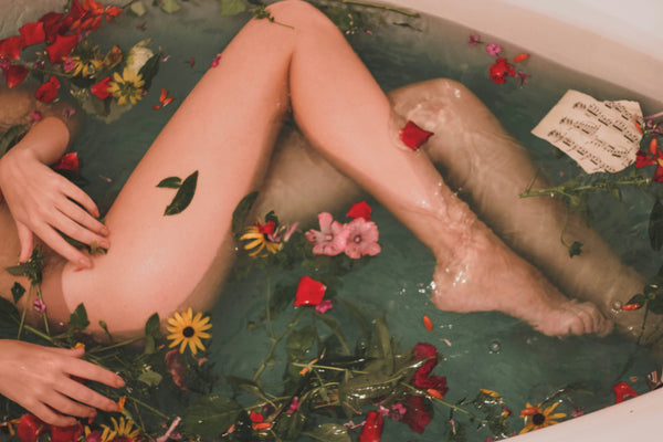 A woman taking a flower bath