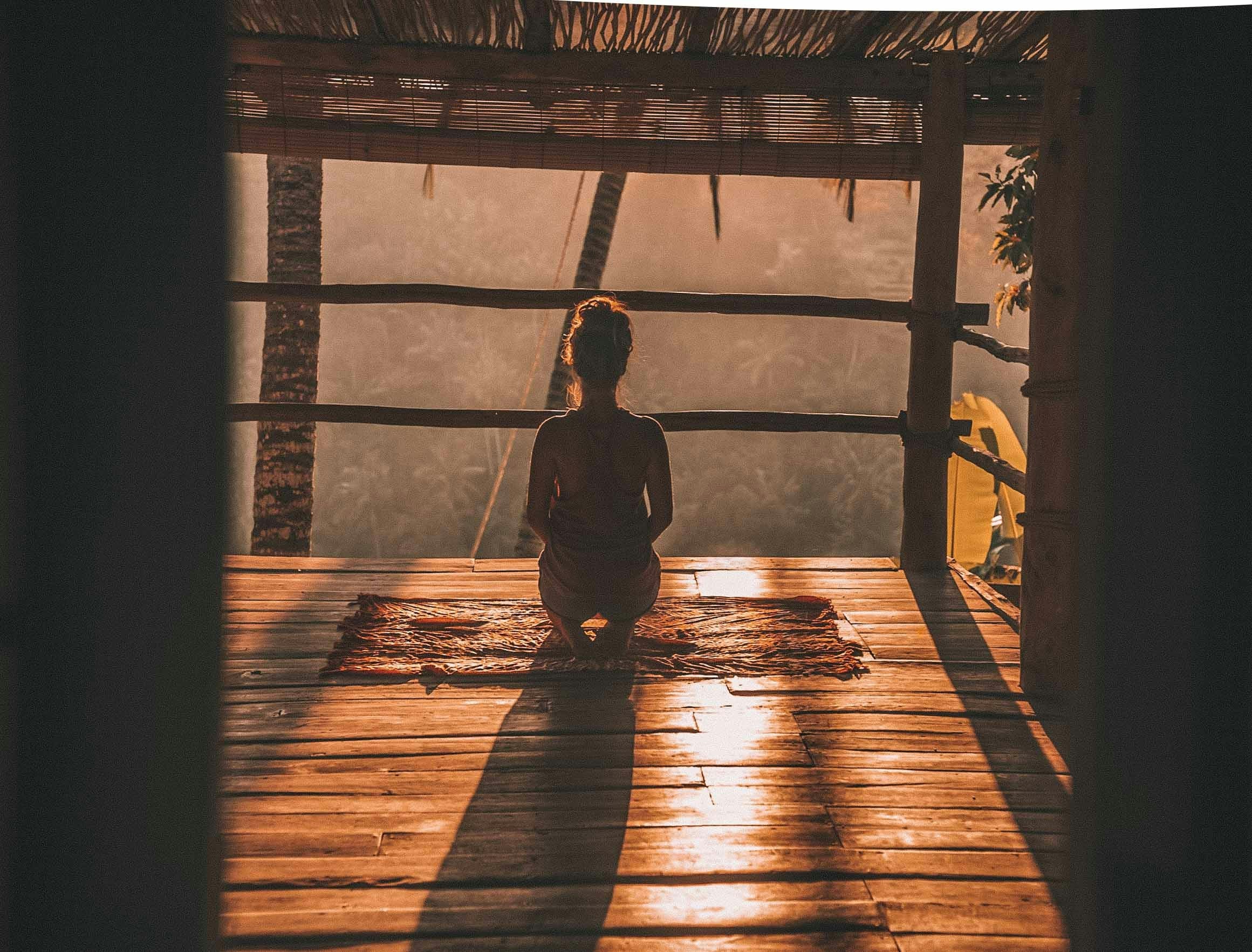 Woman meditating during sunset